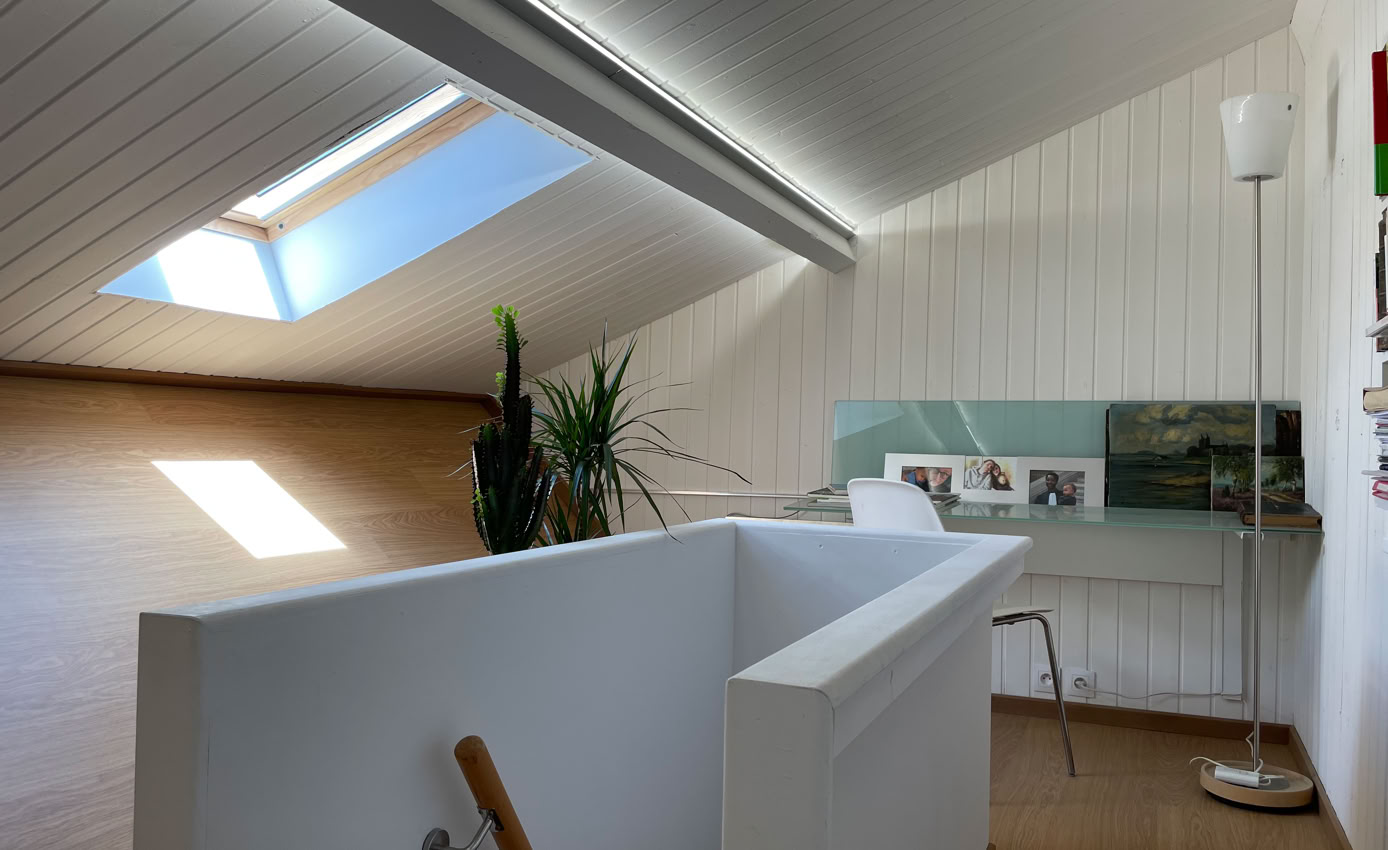 Stairwell and light-filled office under the roof of the urban tiny house in Vaulx-en-Velin.