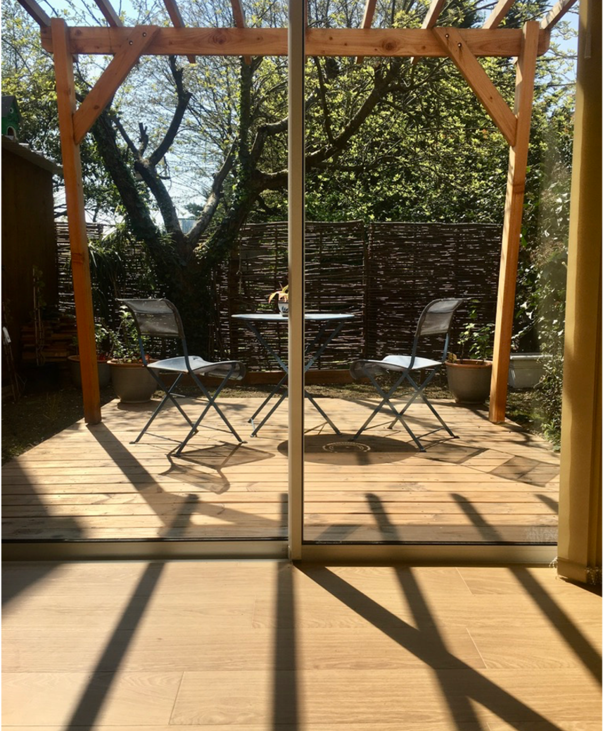 Photo of a wooden terrace with pergolas from a project carried out by the agency.